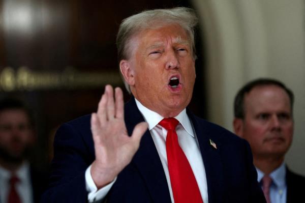 Donald Trump gestures while talking to the media during a break as he attends trial in a civil fraud case brought by state Attorney General Letitia James against him, his adult sons, the Trump Organization and others in New York City.